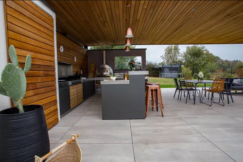 Large concrete pavers patio idea with outdoor kitchen