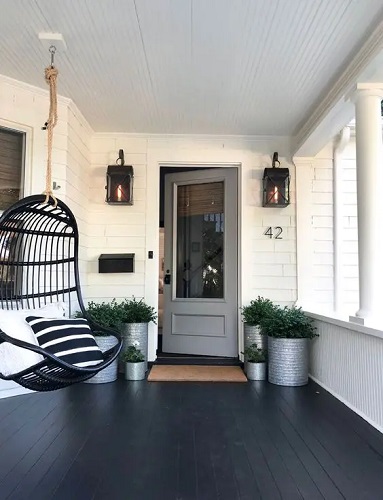 Larger modern front porch with black planked floor idea