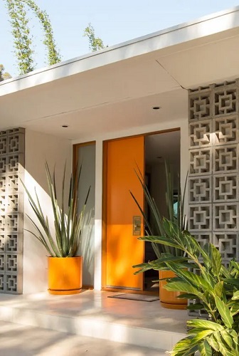 Tiny modern front porch with bold orange door